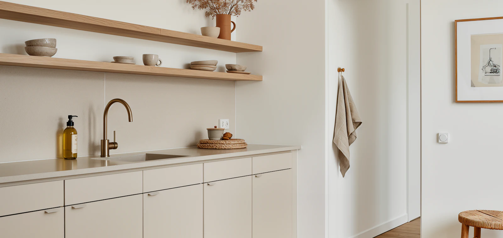 Kitchen island lit by a row of hanging pendant lights